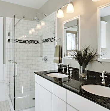 bathroom remodeling with black granite countertops and white tile walls