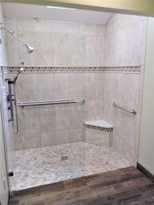 luxury bathroom remodeling with large walk in shower, multi colored tile flooring