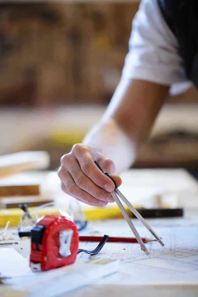 man working on blueprints during construction project, home addition planning.